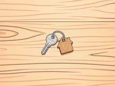 Llaves y llavero de la casa en la cerradura de la puerta abierta